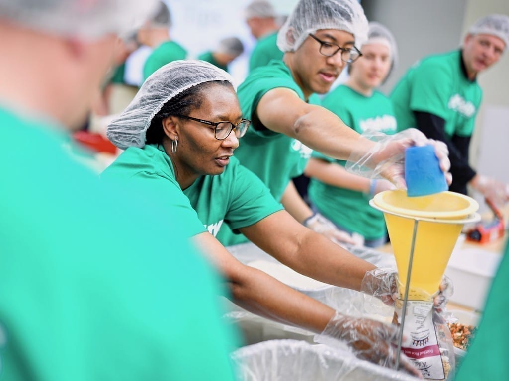 Volunteers packing food.