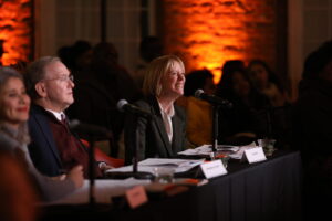 Congressman James Langevin, Eileen Hayes, president and CEO of Amos House, and Maria Kasparian, executive director of Edesia, judge the final pitches.