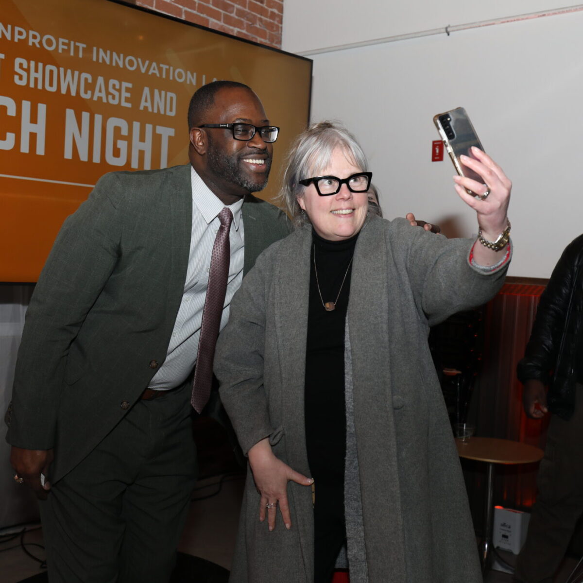Lanre Ajakaiye, chief development officer for United Way of Rhode Island, takes a selfie with a community member.