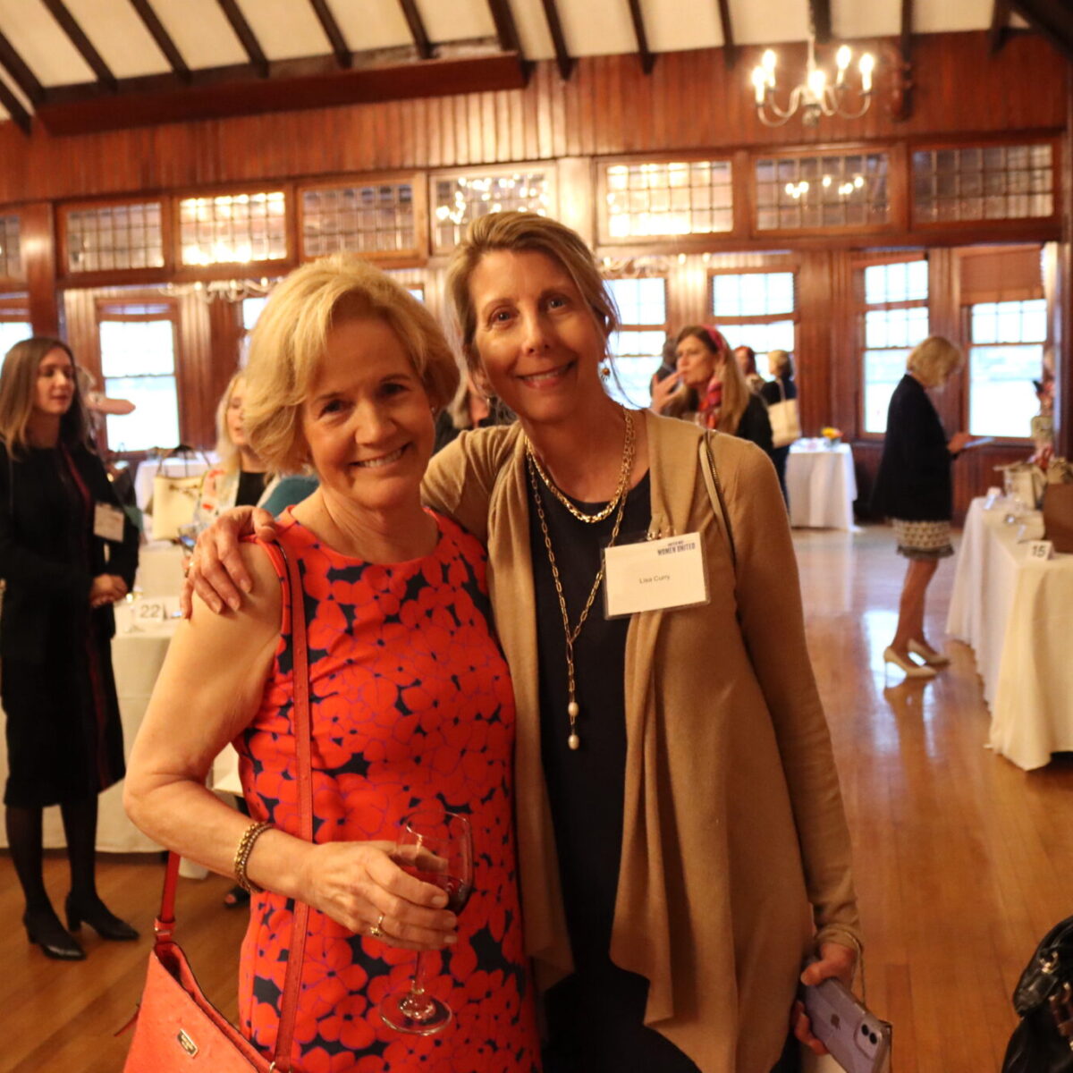 Peggy Lamb, outgoing chair of the Women United Executive Committee, poses with Lisa Curry.