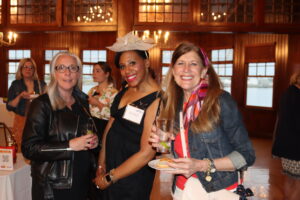 Women United members Melissa Emidy, Stephanie Pelletier, and Carolyn Killian pose for a photo.