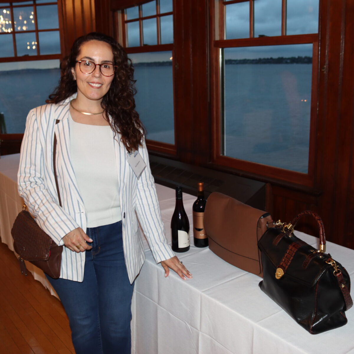 Attendee Ruth DiGiovanni poses with two purses.