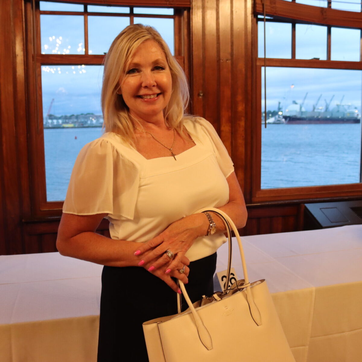 An attendee poses with a purse.