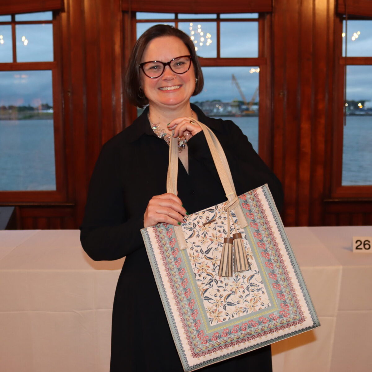 An attendee poses with a purse.