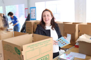 Emily McHugh, director of strategic initiatives for SQA Group, sorts books.