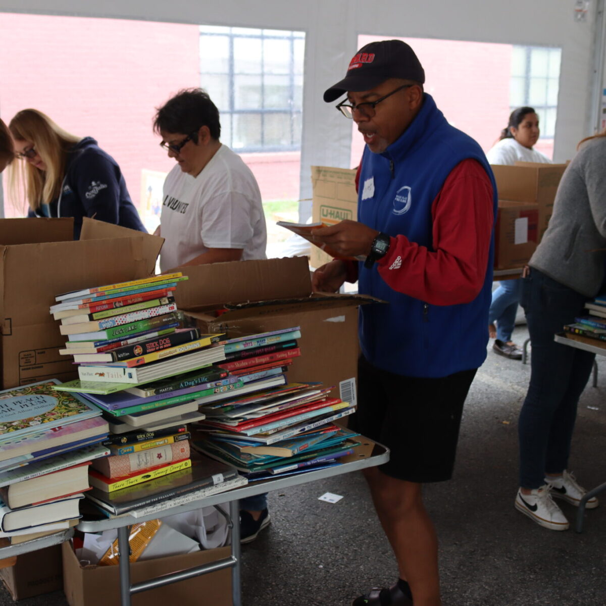 A volunteer looks at a book with an amazed expression.