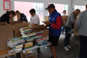 A volunteer looks at a book with an amazed expression.