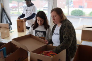 Volunteers sort books.