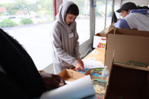 A volunteer labels books.