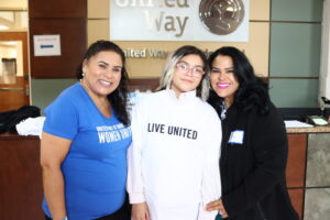 Women United member Sandra Mazo poses with other volunteers.