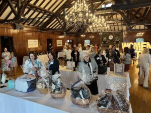 Women United members and friends browse purses in the silent auction.