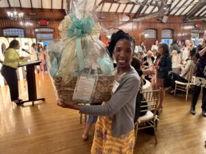 Paige Clausius-Parks, executive director of Rhode Island KIDS COUNT, poses with a door prize.