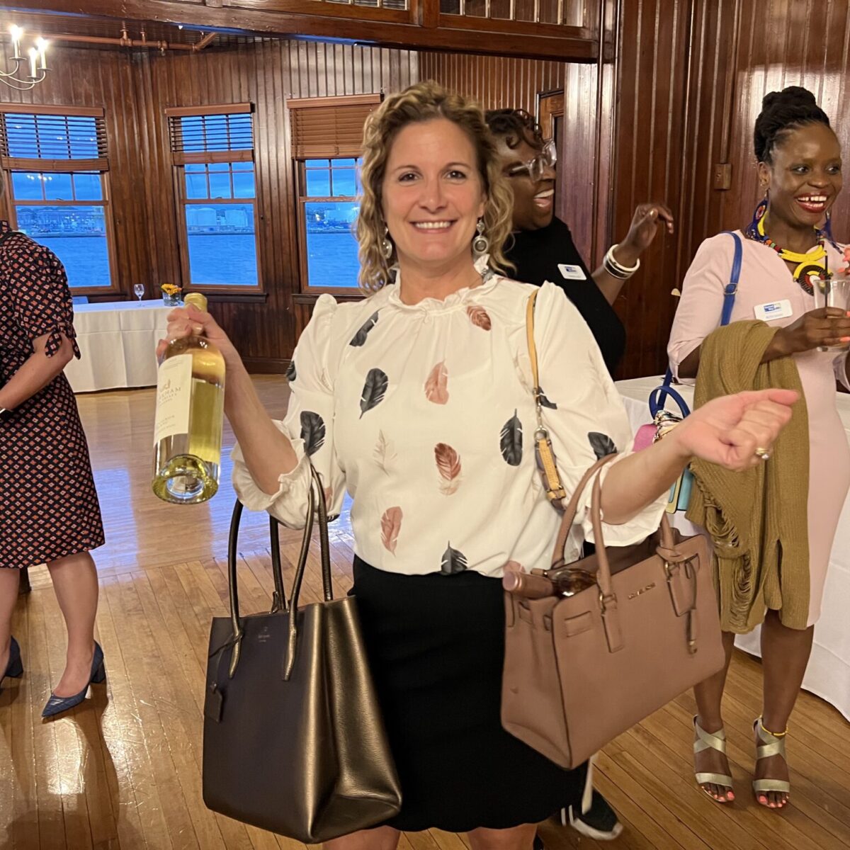 An attendee poses with purses.