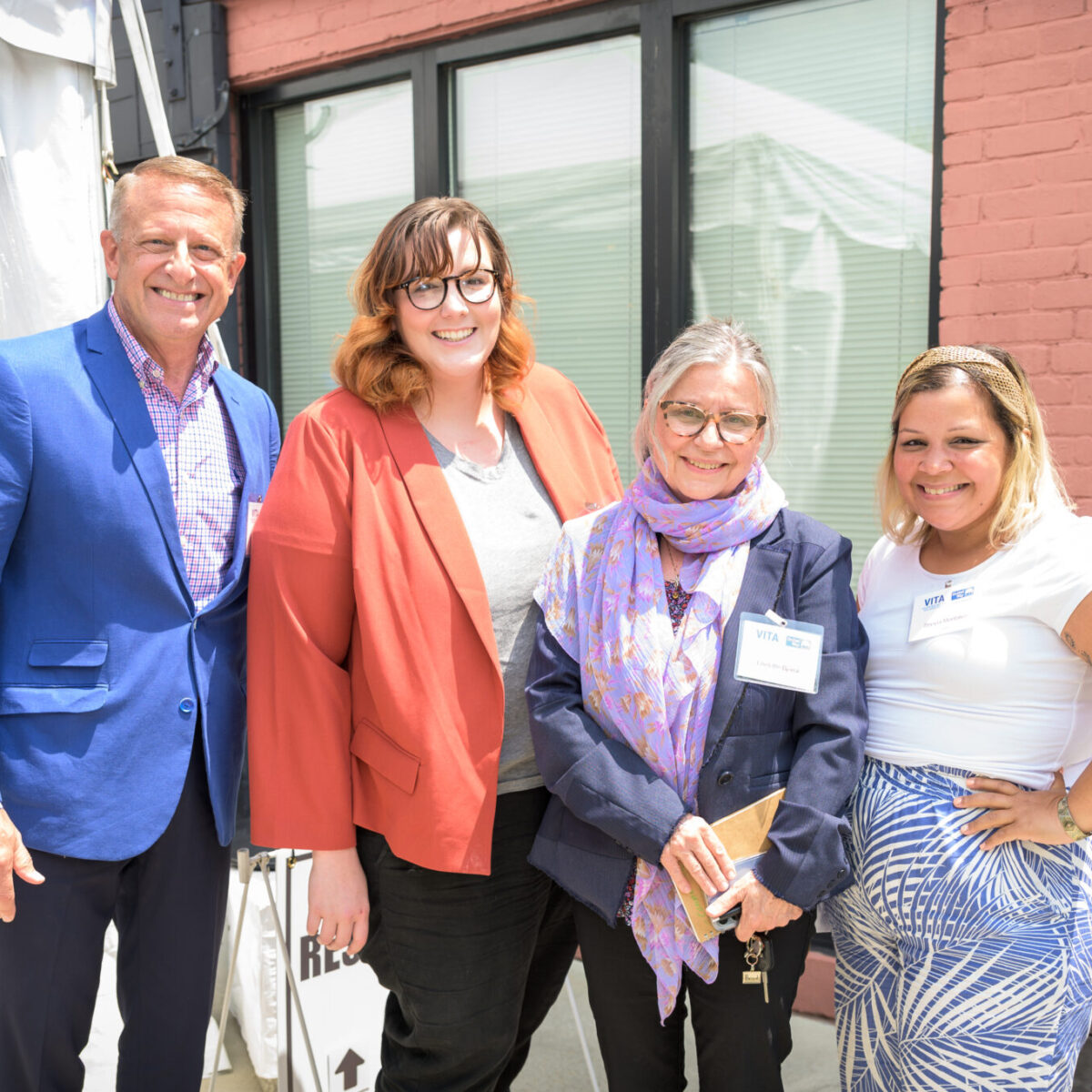 Sheyla Montalvo, program officer for housing initiatives at United Way of Rhode Island, poses with three other attendees.