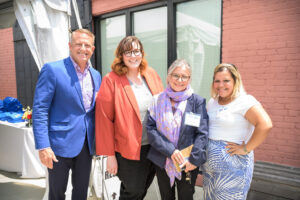 Sheyla Montalvo, program officer for housing initiatives at United Way of Rhode Island, poses with three other attendees.