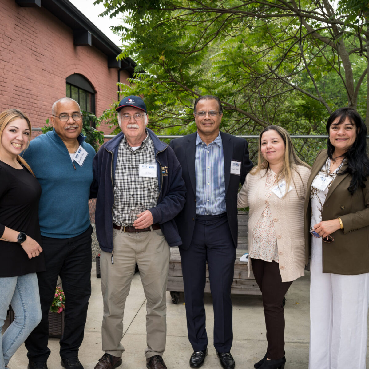 Volunteer Income Tax Assistance volunteers and partners pose on the patio at United Way of Rhode Island.