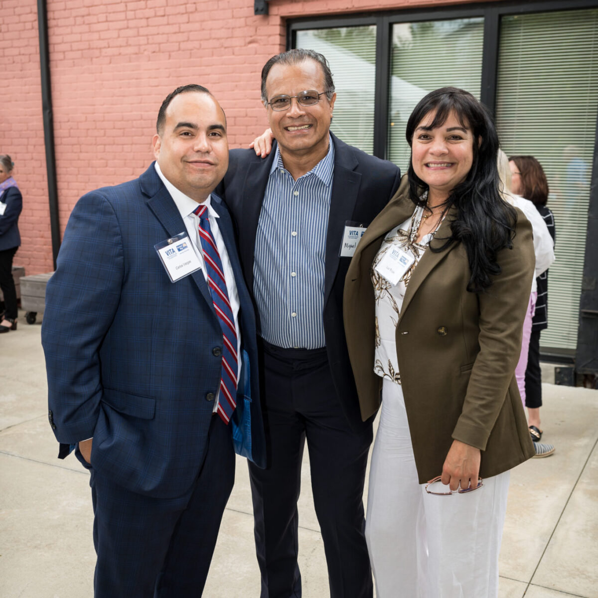 Carlos Vargas, AVP/community development at Navigant Credit Union, poses with two other attendees.
