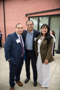 Carlos Vargas, AVP/community development at Navigant Credit Union, poses with two other attendees.