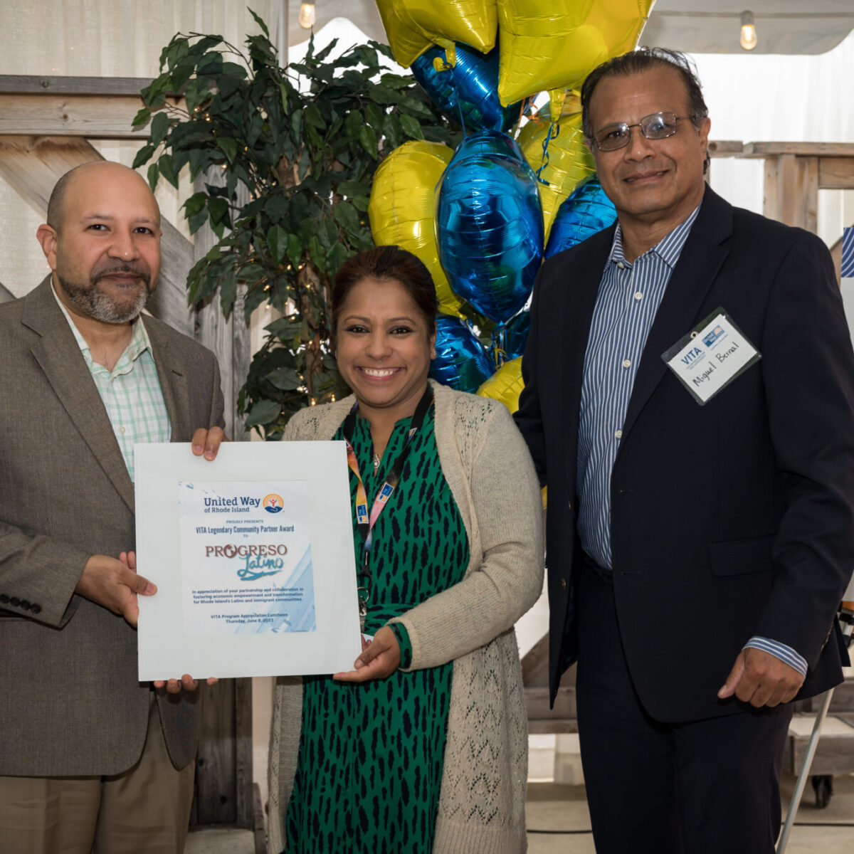 Roshni Darnal presents the VITA Legendary Community Partner Award to Progreso Latino.
