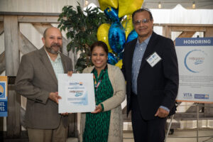 Roshni Darnal presents the VITA Legendary Community Partner Award to Progreso Latino.
