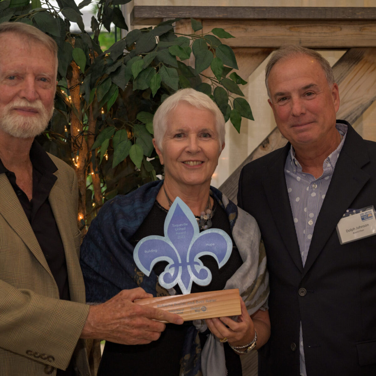 Roberta Butler and Bott Ikeler, recipients of the Tocqueville United Award 2023, with Dolph Johnson.
