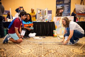 Youth interacting with the University of Rhode Island's geology and geological oceanography display.