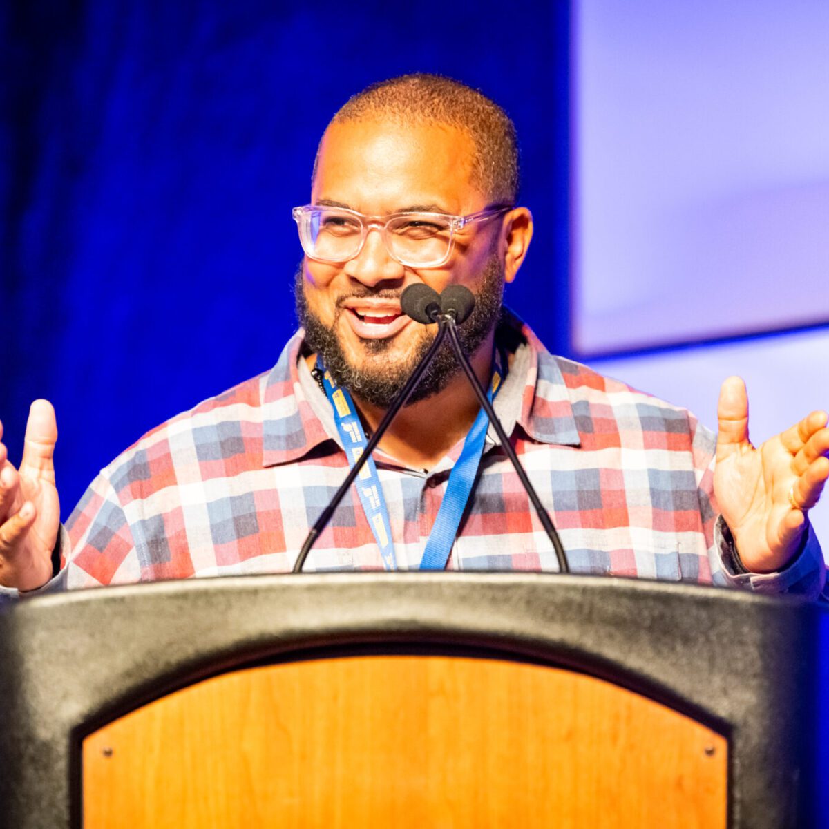 Juan Wilson Jr., founder and CEO of The MUSE Foundation of Rhode Island, speaking from a podium.