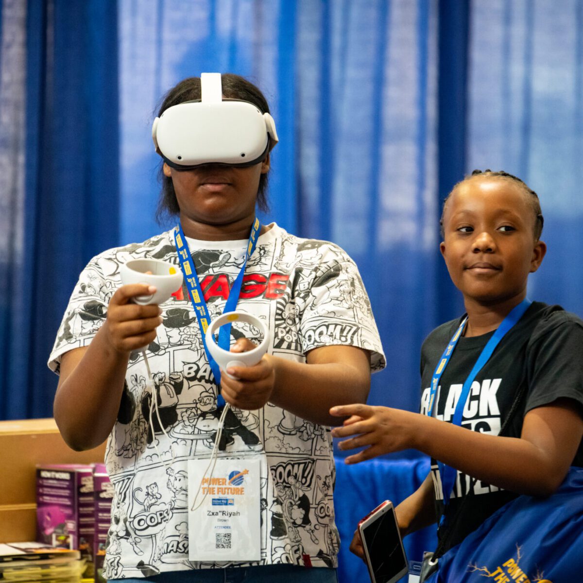 Youth interacting with extended reality (XR) technology.