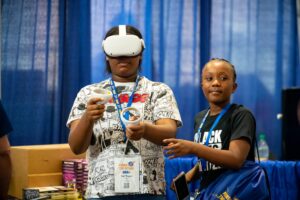 Youth interacting with extended reality (XR) technology.