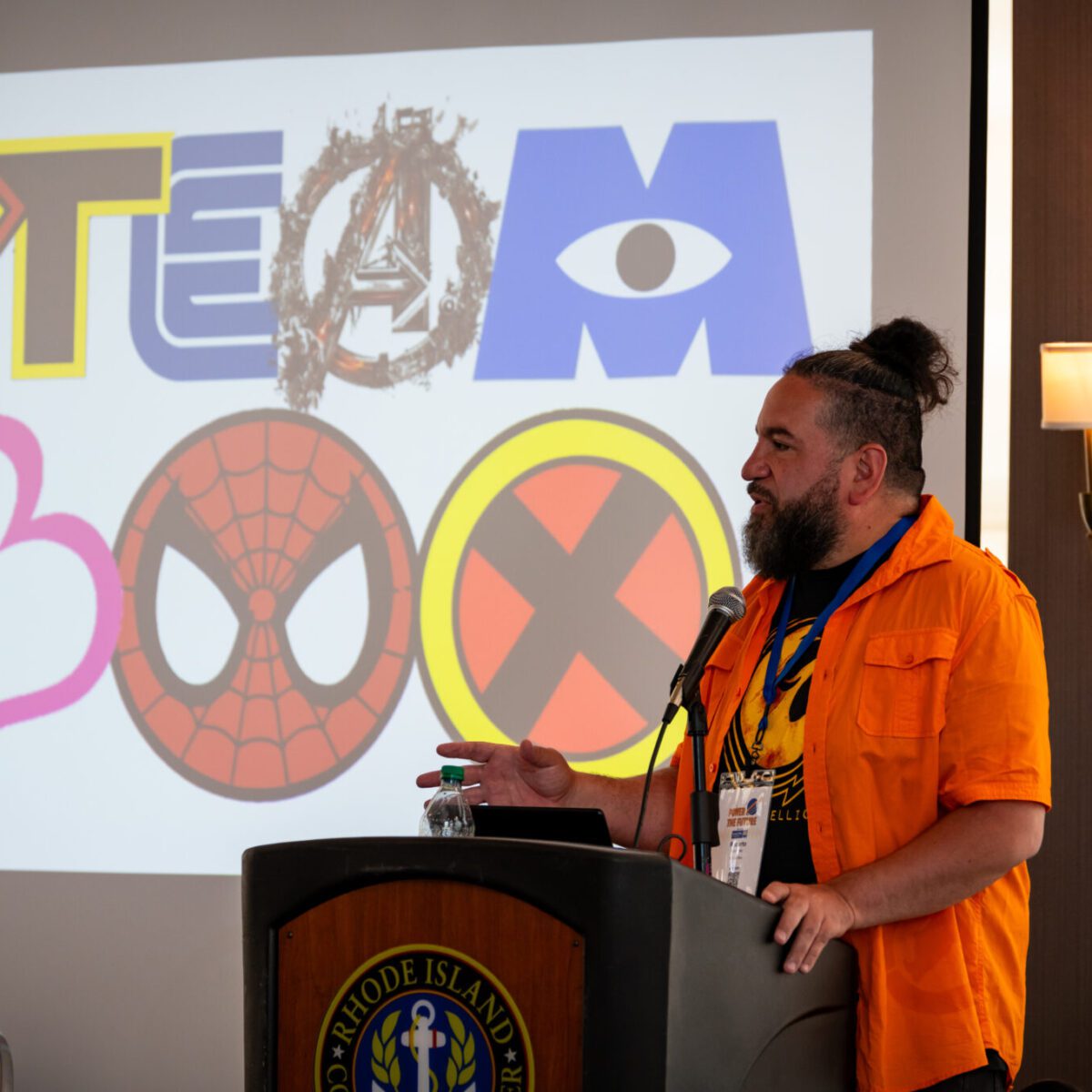 Roberto Gonzalez, executive director of STEAM Box, speaking from a podium.