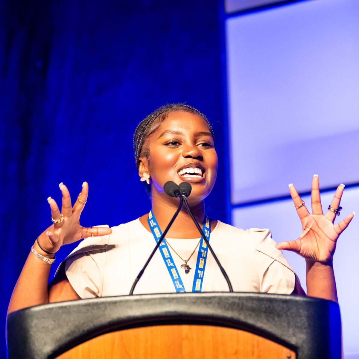 Zainabou Thiam, CEO of Sunu Body and co founder and president of Silence is Violence: 401, speaking from a podium.