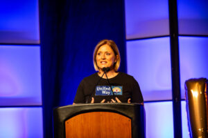 Cortney Nicolato, president and CEO of United Way of Rhode Island, speaking from a podium.