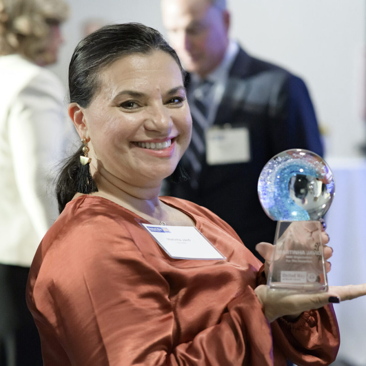 Martinha Javid posing with the John H. Chafee Live United Award.