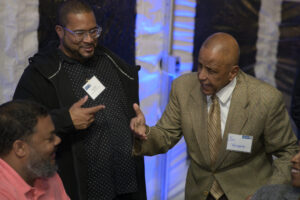 Justin Case, Juan Wilson, and Jim Vincent engaging in a spirited conversation.