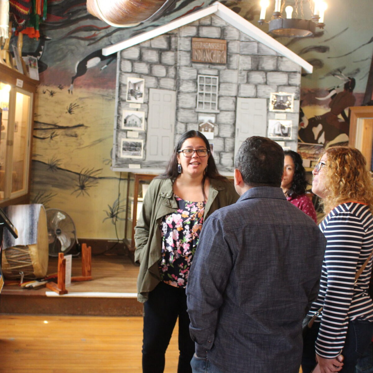 Samantha Cullen-Fry stands in front of a exhibit at the Tomaquag Musuem