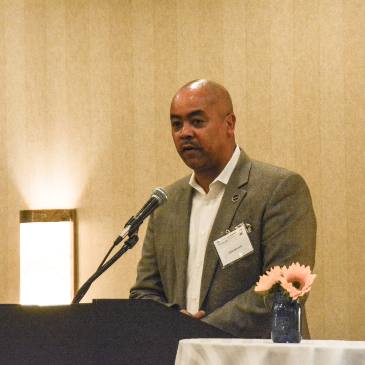 Kyle Bennett, senior director of policy and equity for United Way of Rhode Island, emceeing.