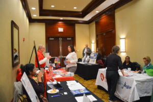 Conference attendees speaking with representatives from local organizations that support healthy aging.