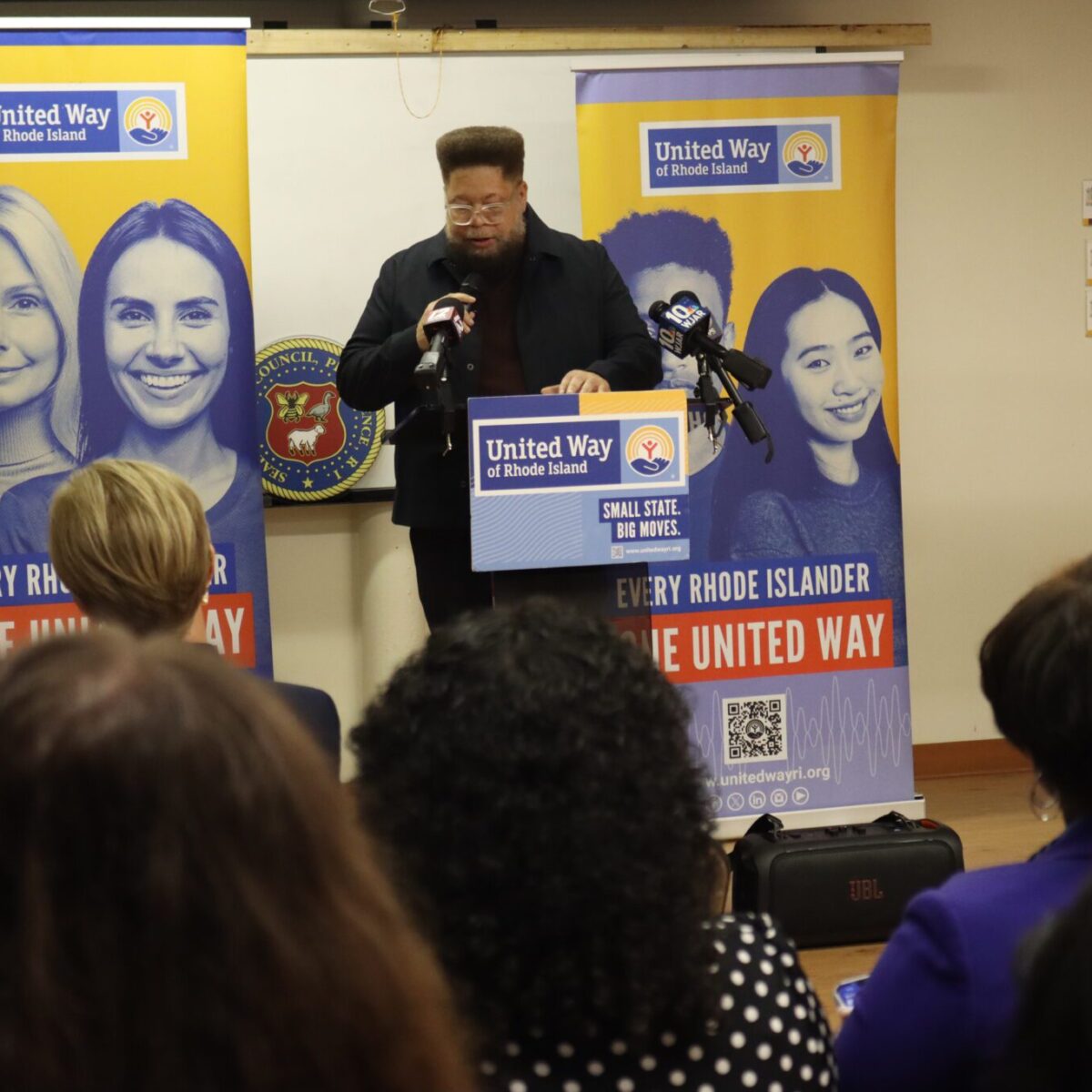 Rodney Davis, Team United member and chairperson of the Providence Municipal Reparations Commission, speaking from a podium.