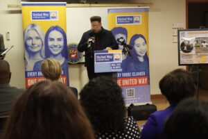Rodney Davis, Team United member and chairperson of the Providence Municipal Reparations Commission, speaking from a podium.