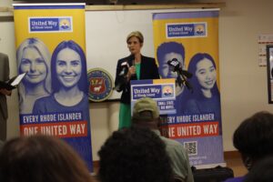 Cortney Nicolato, president and CEO of United Way of Rhode Island, speaking from a podium.