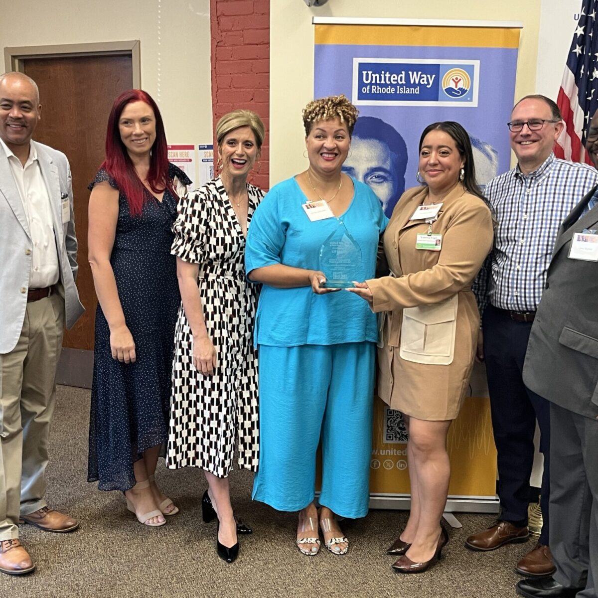 Members of Team United posing with Lifespan's Christin Zollicoffer and Vanessa Vigil.