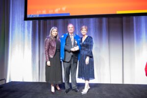 Dolph Johnson, outgoing board chair for United Way of Rhode Island, posing with Cortney Nicolato and Paola Fernandez.