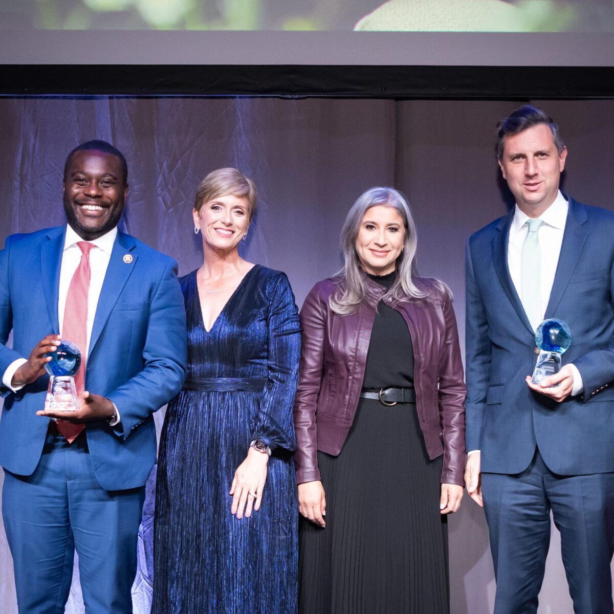 Congressmen Seth Magaziner and Gabe Amo, recipients of the Community United Award, with Cortney Nicolato and Paola Fernandez.