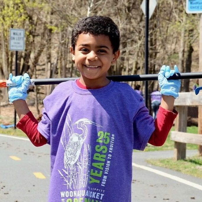 Little boy doing community cleanup with mom