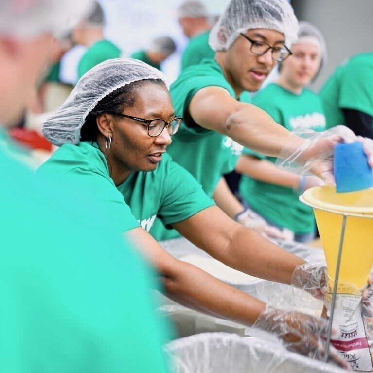 Volunteers packing food.